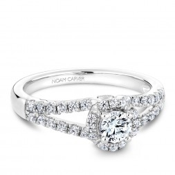 A Carver Studio white gold engagement ring with an oval halo and 39 diamonds.