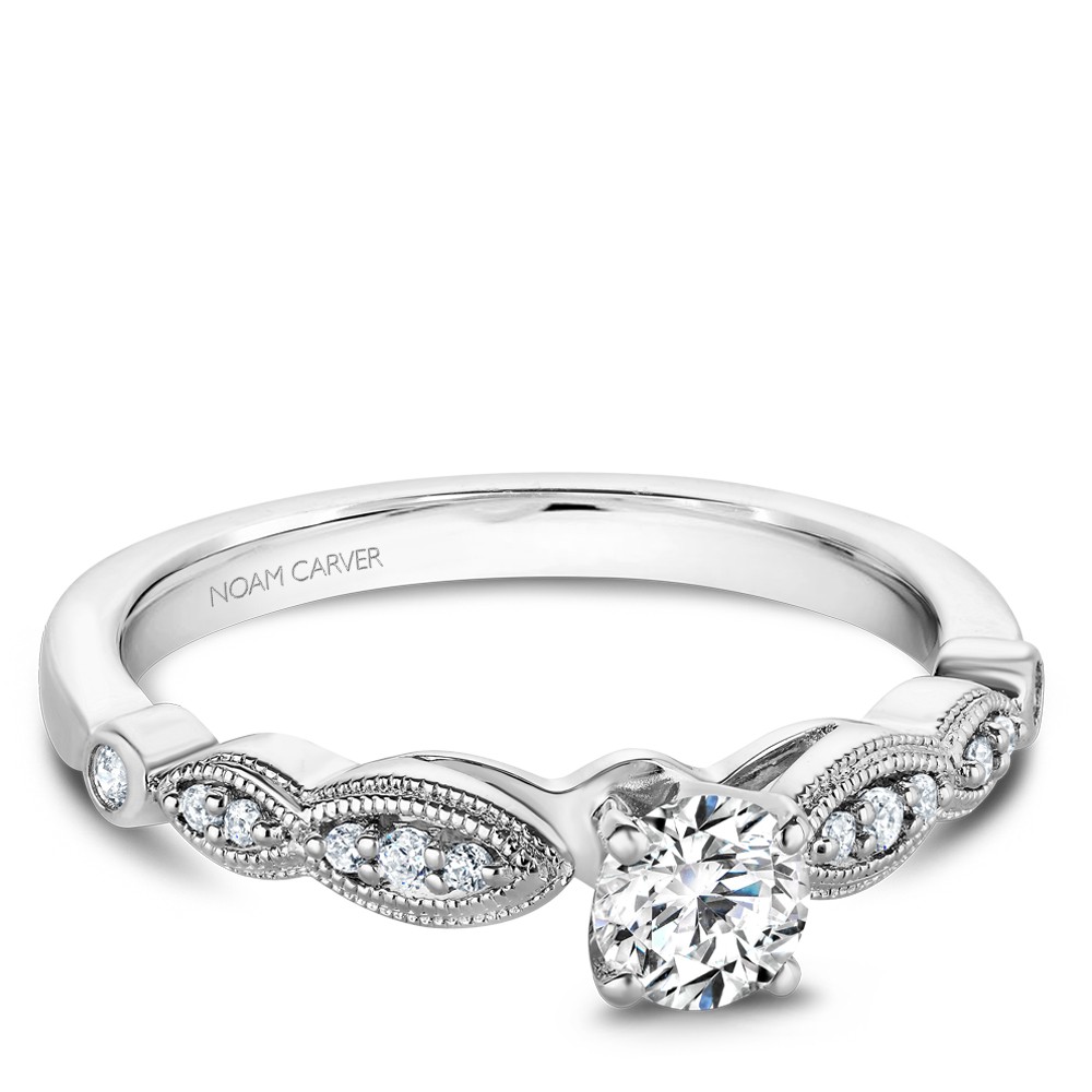 A floral Carver Studio white gold engagement ring with 13 diamonds.