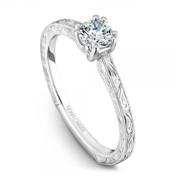 A Carver Studio engraved white gold engagement ring with a round center stone.