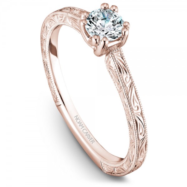 A Carver Studio engraved rose gold engagement ring with a round center stone.