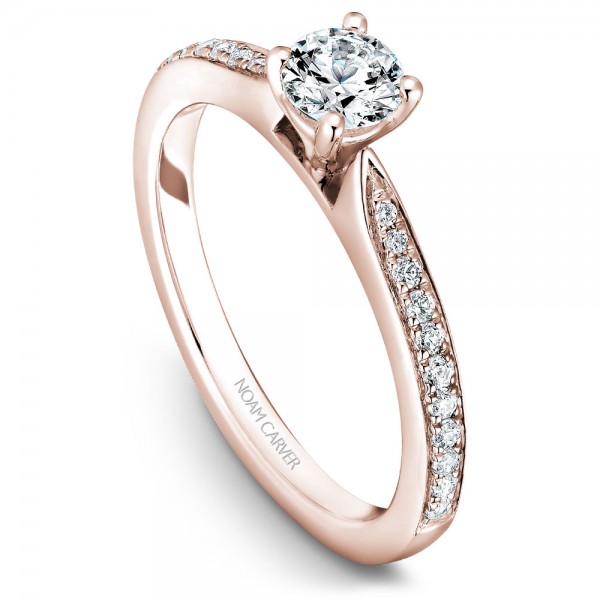 A solitaire Carver Studio rose gold engagement ring with a round center stone and 23 diamonds.