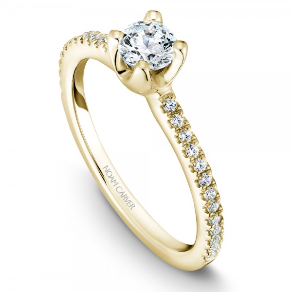 A floral Carver Studio yellow gold engagement ring with a round center stone and 27 diamonds.