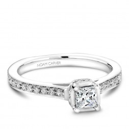 A solitaire Carver Studio white gold engagement ring with a princess diamond and 35 diamonds.