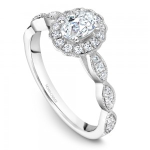 A floral Carver Studio white gold engagement ring with an oval halo and 31 diamonds.