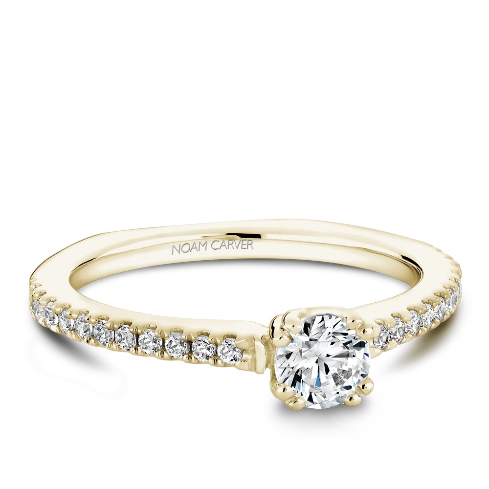 A Carver Studio yellow gold engagement ring with 23 diamonds.