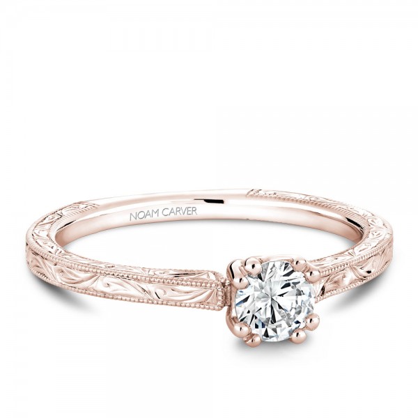 A Carver Studio engraved rose gold engagement ring with a round center stone.