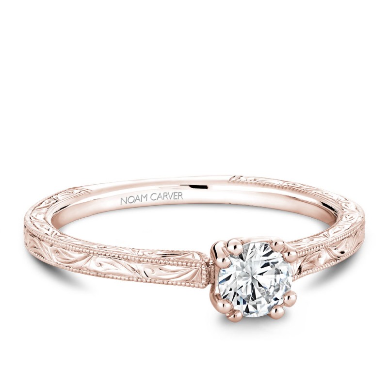 A Carver Studio engraved rose gold engagement ring with a round center stone.