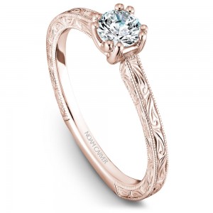 A Carver Studio engraved rose gold engagement ring with a round center stone.