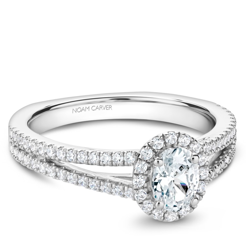 A Carver Studio white gold engagement ring with an oval center stone.