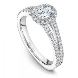 A Carver Studio white gold engagement ring with an oval center stone.