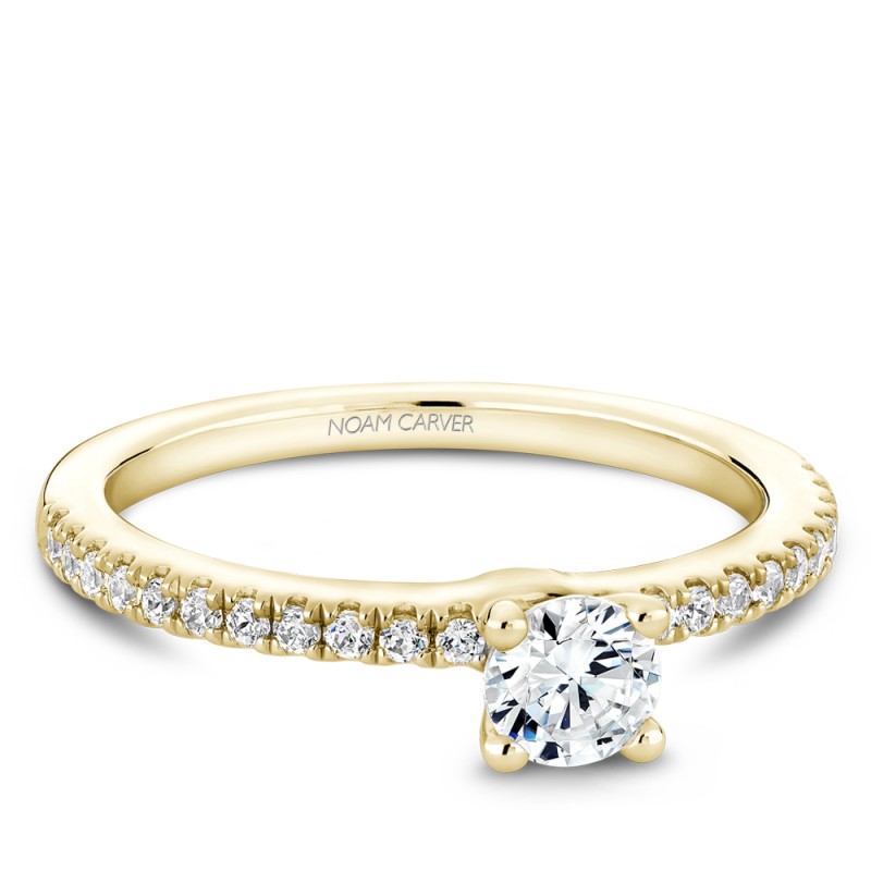 A solitaire Carver Studio yellow gold engagement ring with 23 diamonds.