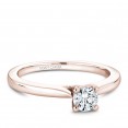 A solitaire Carver Studio rose gold engagement ring with a round center stone.