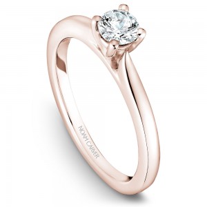 A solitaire Carver Studio rose gold engagement ring with a round center stone.