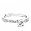 A solitaire Carver Studio white gold engagement ring with a round center stone and 23 diamonds.