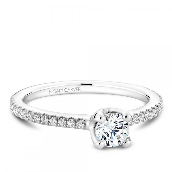 A floral Carver Studio white gold engagement ring with a round center stone and 27 diamonds.