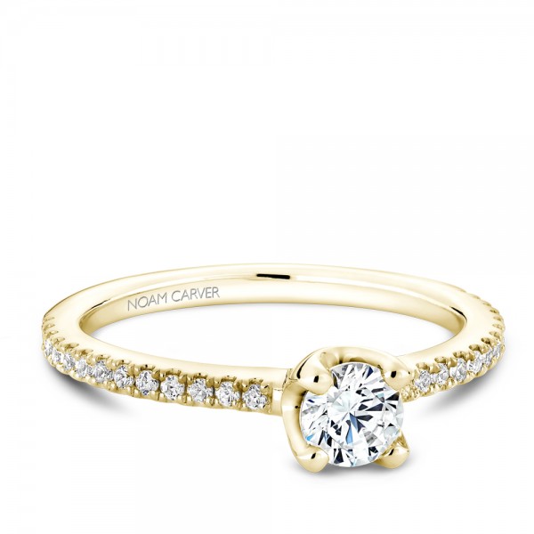 A floral Carver Studio yellow gold engagement ring with a round center stone and 27 diamonds.