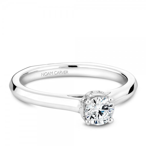 A solitaire Carver Studio white gold engagement ring with 15 diamonds.