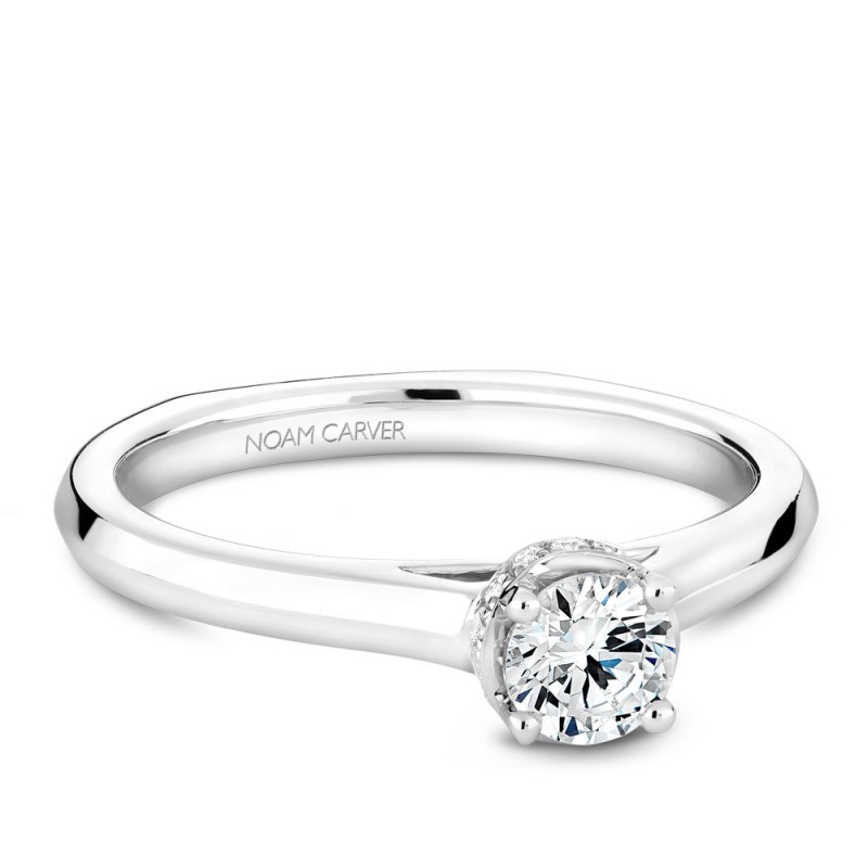 A solitaire Carver Studio white gold engagement ring with 15 diamonds.
