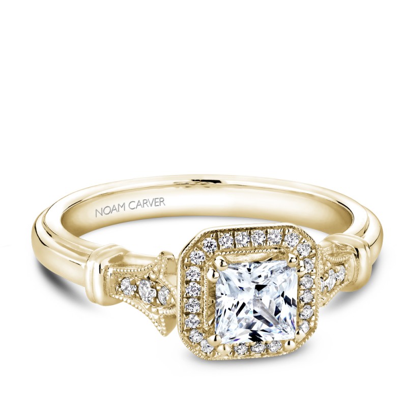 A vintage Carver Studio yellow gold engagement ring with a princess center stone and 23 diamonds.