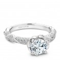 A floral Carver Studio white gold engagement ring with a round center stone and 101 diamonds.