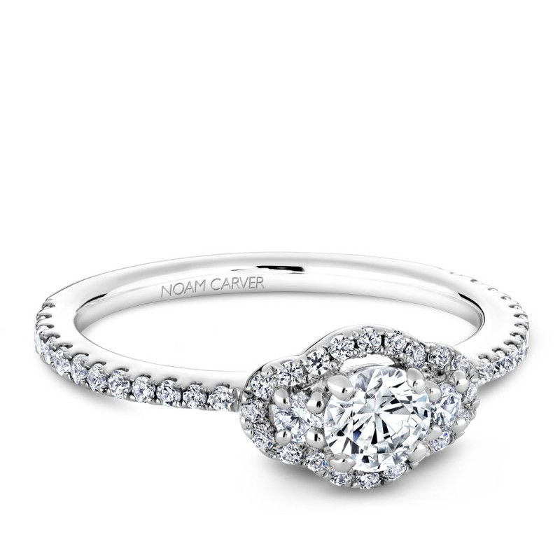 A 3-stone Carver Studio white gold engagement ring with 47 diamonds.