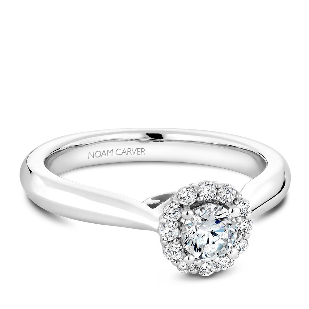 A floral Carver Studio white gold engagement ring with a halo and 13 diamonds.