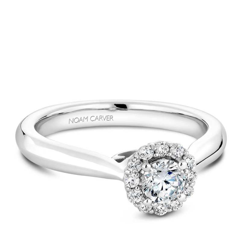 A floral Carver Studio white gold engagement ring with a halo and 13 diamonds.
