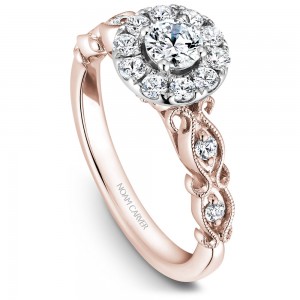 A floral Carver Studio white and rose gold engagement ring with a halo and 17 diamonds.