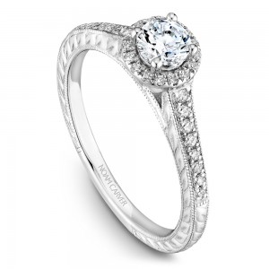 A vintage Carver Studio white gold engagement ring with a halo and 33 diamonds.