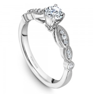 A floral Carver Studio white gold engagement ring with 13 diamonds.