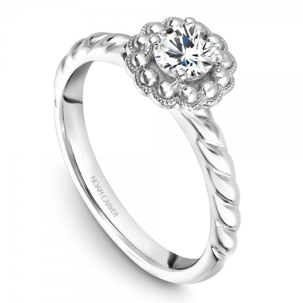 A floral Carver Studio white gold engagement ring with a round center stone.