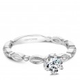 A vintage Carver Studio white gold engagement ring with a round center stone.