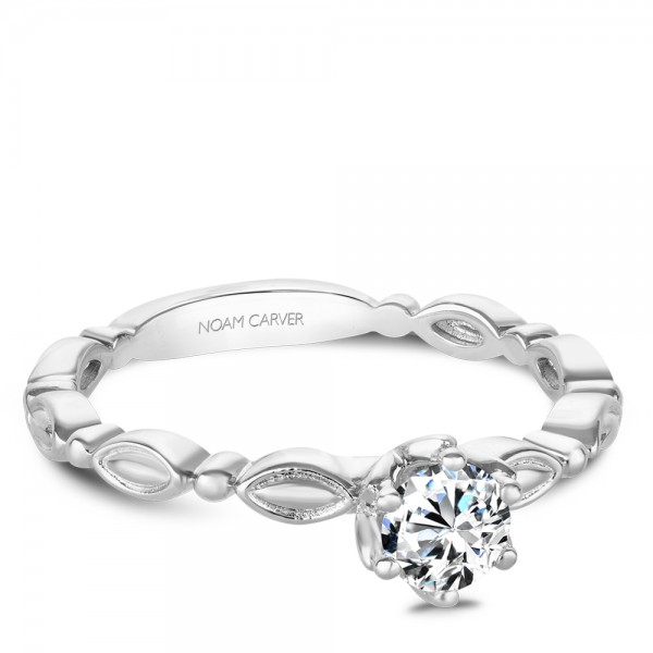 A vintage Carver Studio white gold engagement ring with a round center stone.