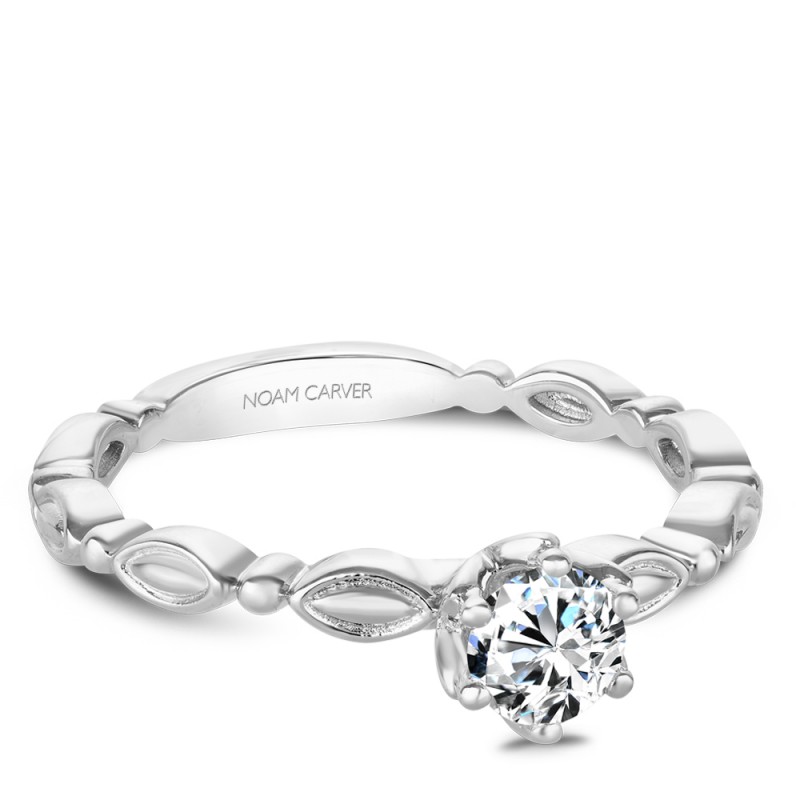 A vintage Carver Studio white gold engagement ring with a round center stone.