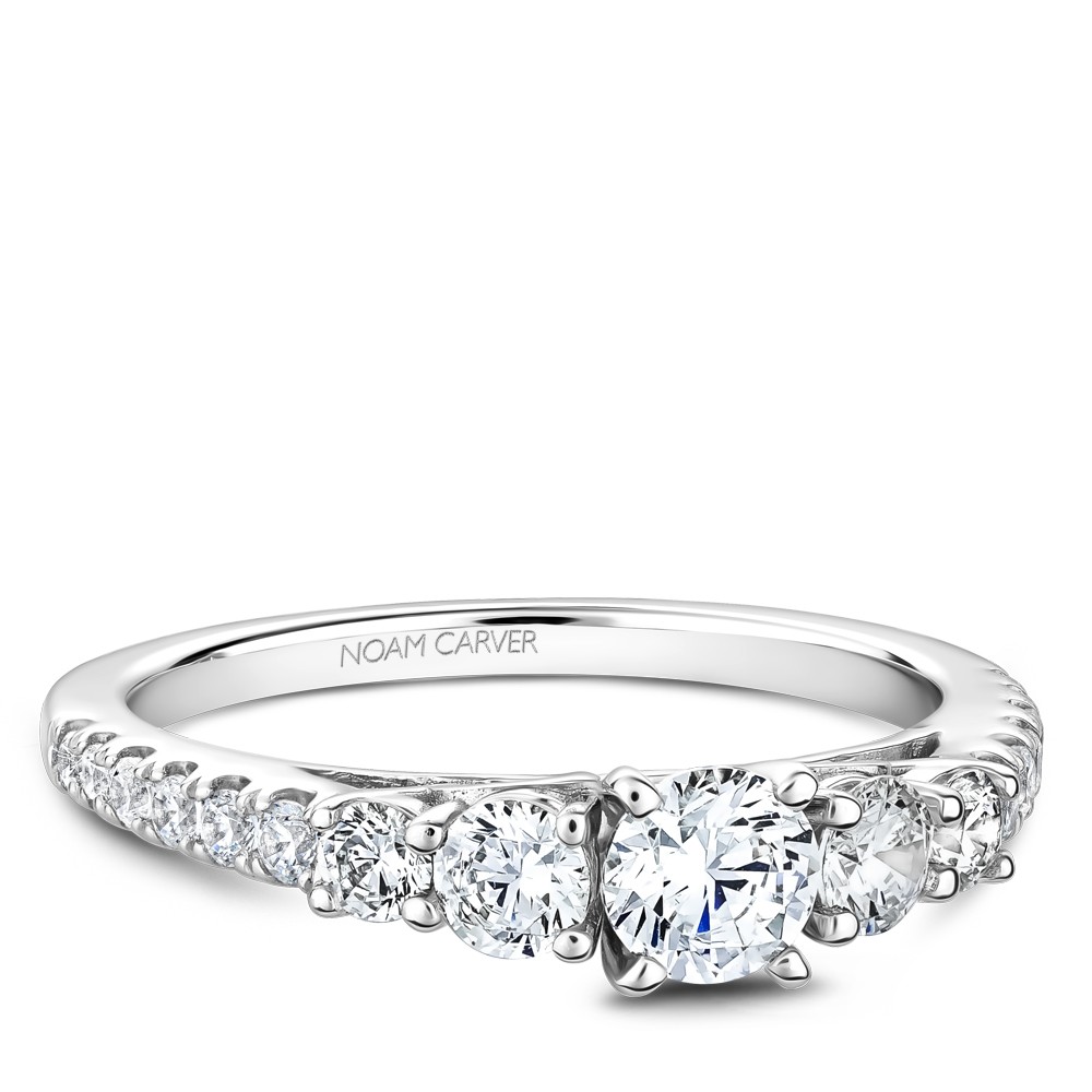 A 3-stone Carver Studio white gold engagement ring with 17 diamonds.