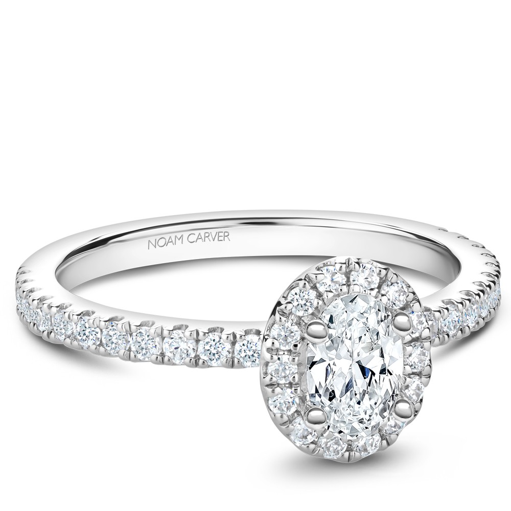 A Carver Studio white gold engagement ring with an oval halo and 37 diamonds.